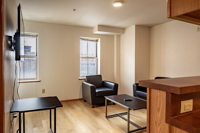 Relax in this bright and cozy living space, perfect for unwinding. - Varsity Campus Apartments