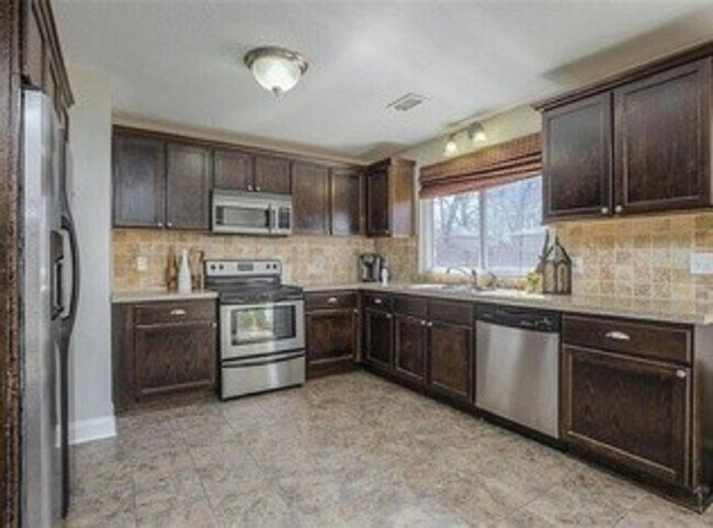 Building Photo - {5611} Updated OP Ranch + Two Car Garage + Fenced Yard and Stamped Concrete Patio Perfect for Spr...