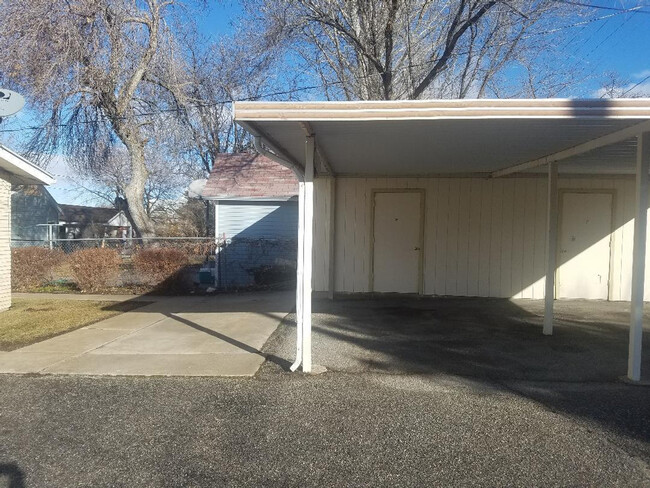 Carport with storage and uncovered parking - 62 N 300 W