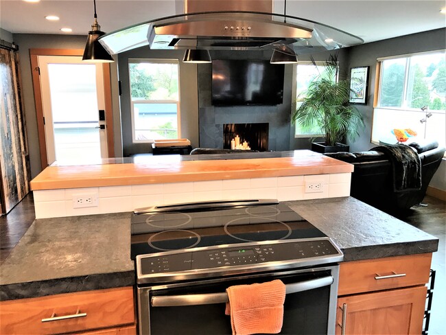 Induction stove and island with bar seating - 6549 40th Ave NE