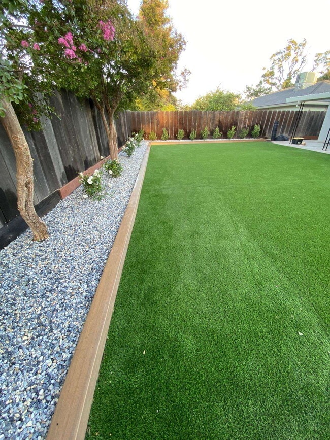 Building Photo - 4-bedroom, 2-bath home with solar, featuring a huge backyard and low-maintenance landscaping with...