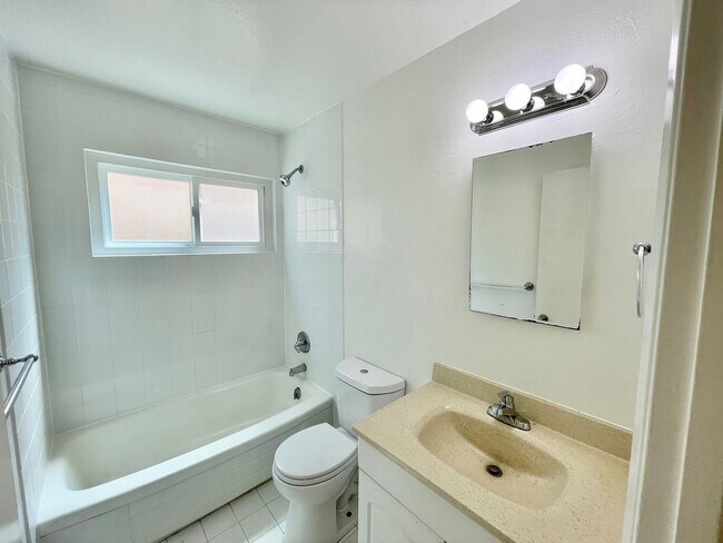 Building Photo - Sunlit 2BD/1BA w/ Private Balcony + Backyard! New Carpet! Assigned Parking! PROGRESSIVE