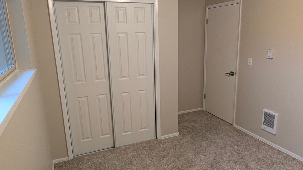 Back bedroom with new closet doors - 729 Pecks Dr