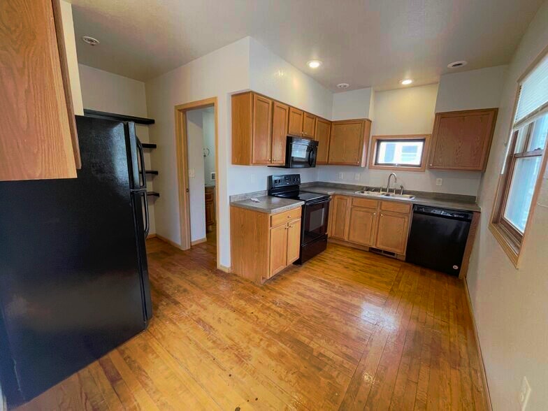 Bright kitchen offering practical workspace and convenient storage for everyday living. - 1016 4th Ave