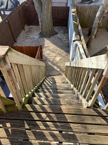 New Patio/deck to courtyard leading to personal parking pad on other side of gate - 1619 Mansfield St