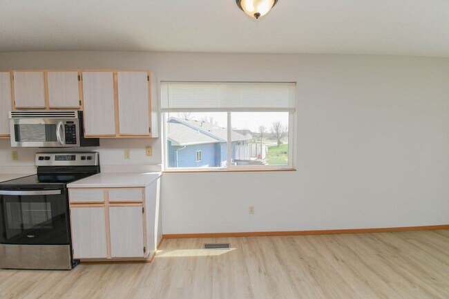 Building Photo - Updated 3BR Split-Level Home with Huge Deck, Fenced Yard & 2-Car Garage Near I-29!