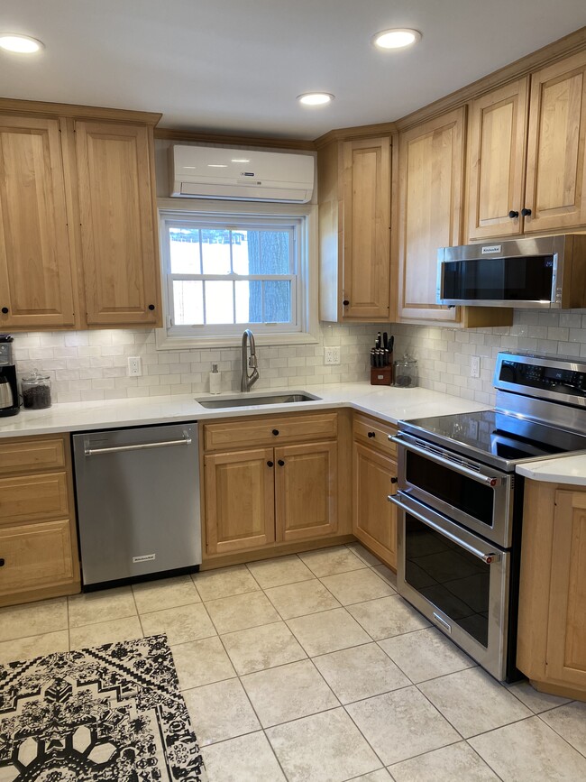 Remodeled kitchen with matching stainless steel appliances and quartz countertops. - 846 N President Ave