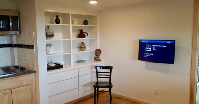 Main living room with built in cabinets and Roku-TV. - 8261 Northrop Plz SW