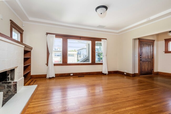 Dining rooLiving room with natural light, bum with wood-paneled walls, built ins, and natural light. - 431 Athol Ave