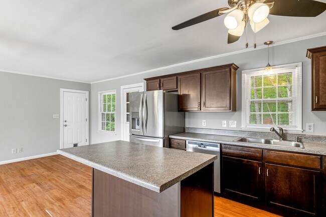 Building Photo - Updated Home, Stainless Steel Appliances, Wood Like Flooring, Deck, Garage!