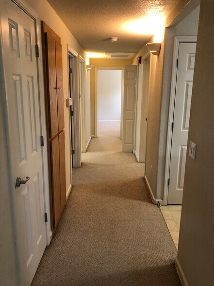 Hallway from living room to 3 bedrooms. Master is at the end.rooms - 10001 Woodcreek Oaks Blvd