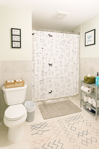 Lower-level bathroom with a full tub, located just off the kitchen with a vented exhaust fan - 56 Jefferson Ave