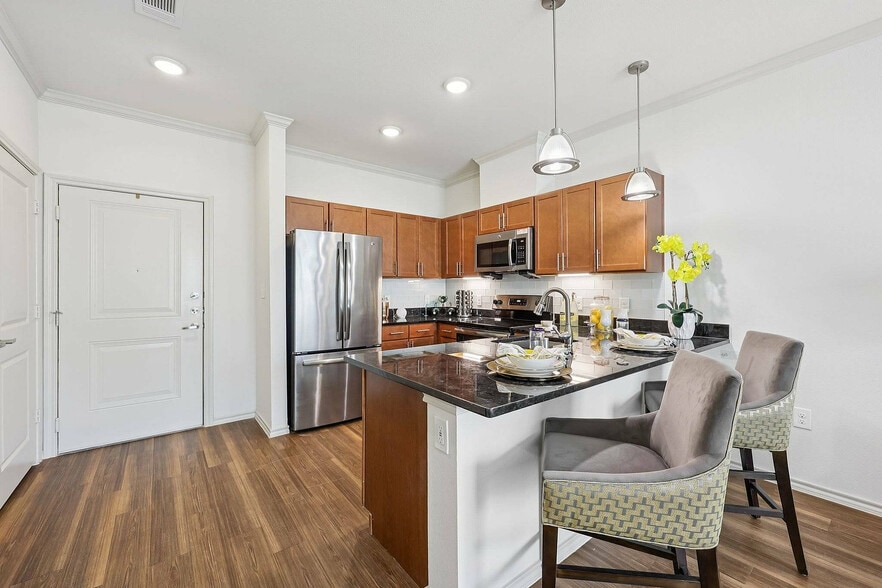 Host friends and family in style with a spacious kitchen island at McDermott 55. - McDermott 55