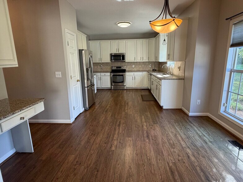 The Kitchen has a pantry, desk area, and breakfast area overlooking the rear deck and backyard - 6419 Woodmont Rd