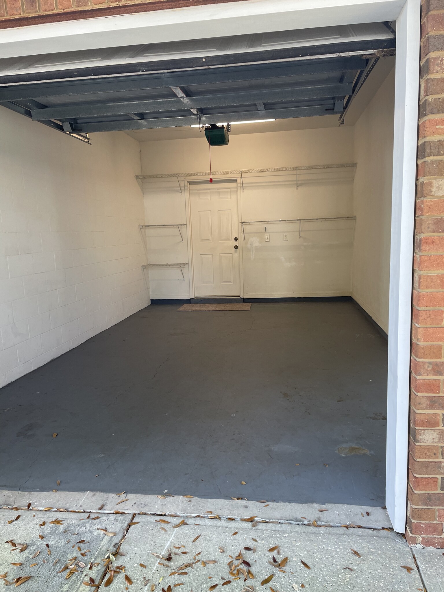 Painted floor garage and wire shelves for organization. - 13200 W Newberry Rd