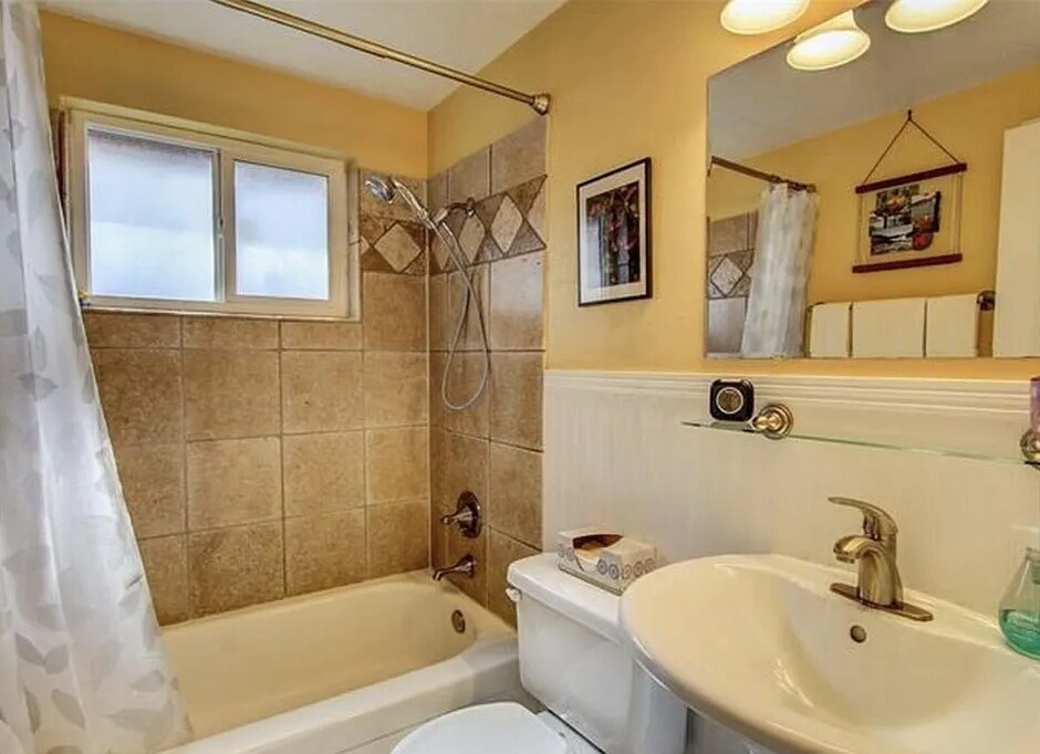 Bathroom with stone-tiled shower/tub, pedestal sink, storage closet, - 2244 N Franklin St