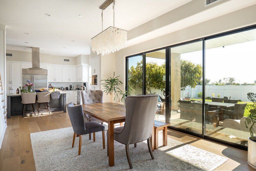 Open concept dining room with access to kitchen and large sliders to backyard - 3687 Valley St
