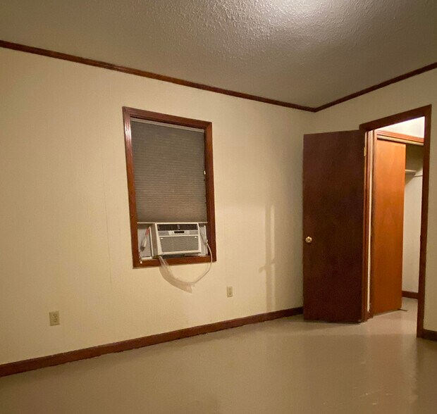 Bedroom view 1: Door to hallway. Window-unit A/C. - 1109 North Yale Street