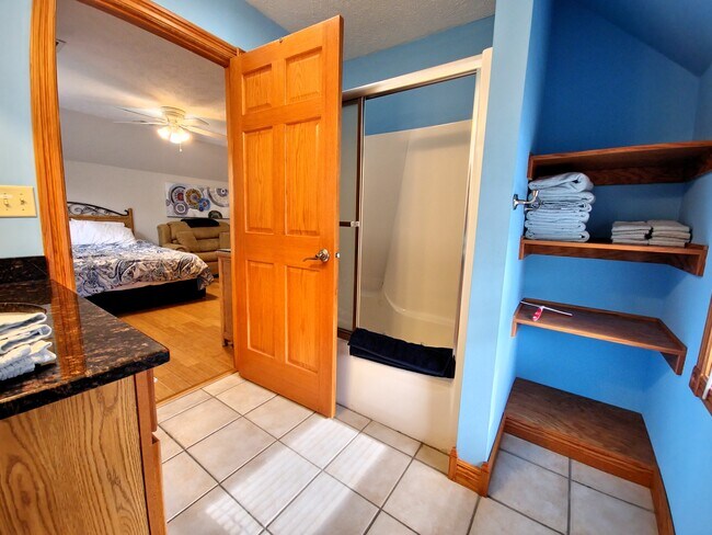 Upstairs master full bath tub/shower and shelving - 503 Chambers St