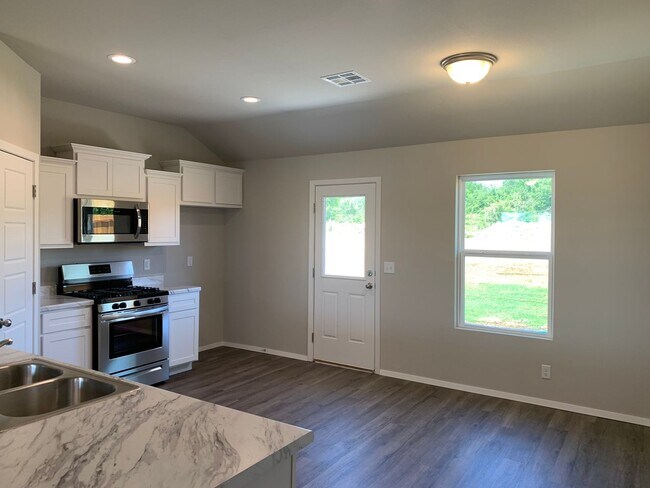 Building Photo - This well-designed 4-bedroom home has a split floor plan that gives the feeling of space.