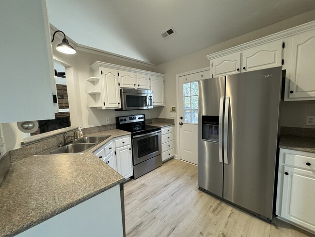 Kitchen with new stainless appliances - 8017 Pine Oak Rd