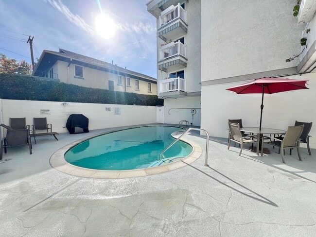 Building Photo - Contemporary 2 Bed Condo with 2 Garage Parking Spaces, Community Pool, and 3 Private Balconies