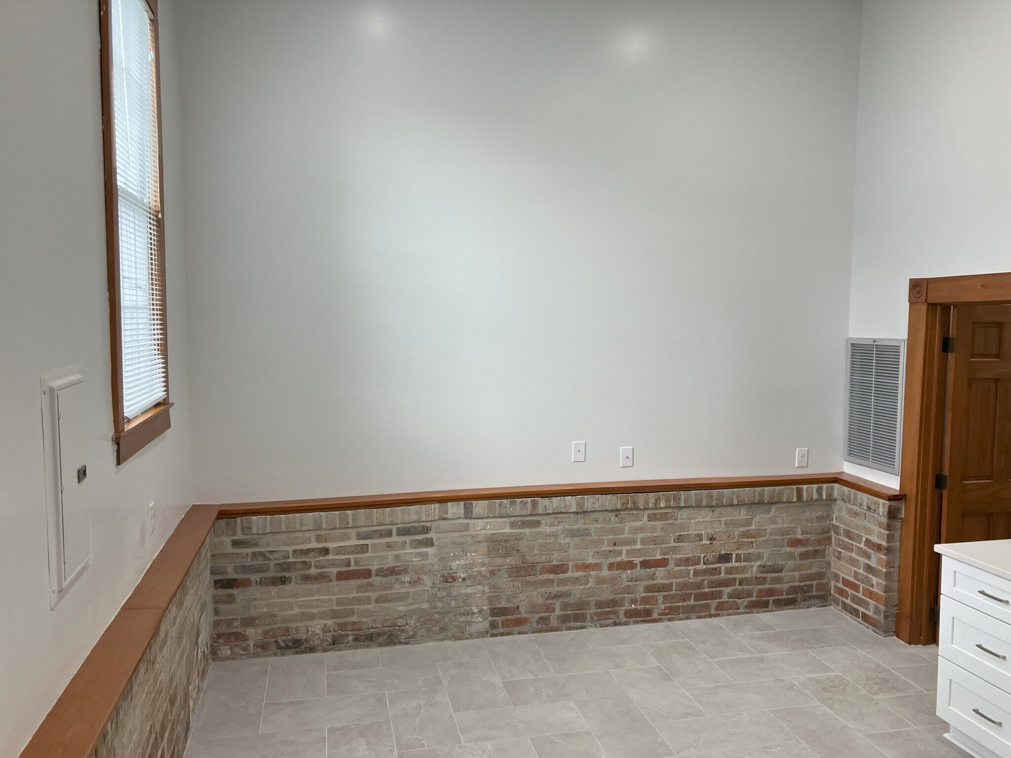 Dining room has original brick accent walls - 2039 Valence St