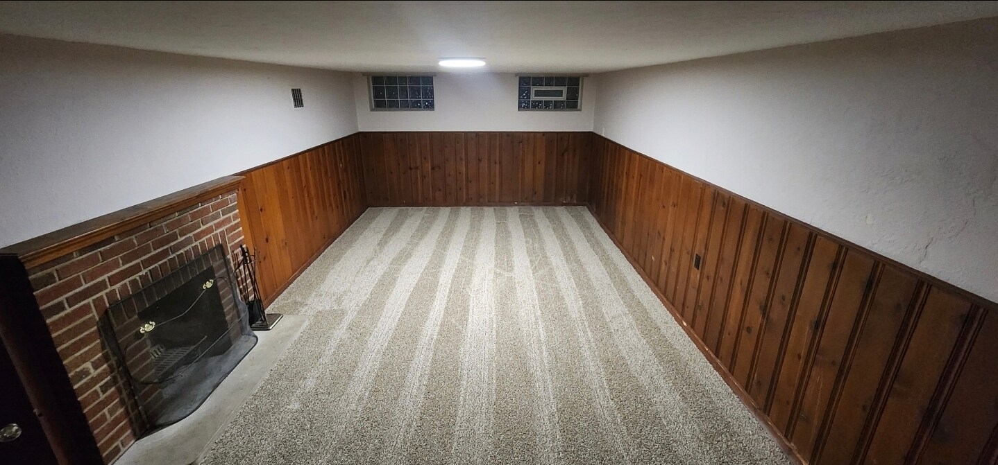 pacious finished basement with plush carpeting, recessed lighting, and a cozy fireplace. Ideal for a - 90 E 216th St