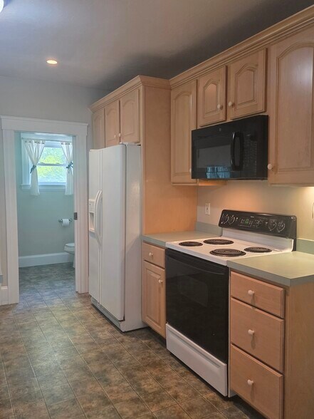 Kitchen looking into 1/2 bath - 27 Granite St