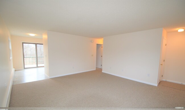 Living area with kitchen to the left and hallway on the right - 395 Valley Rd