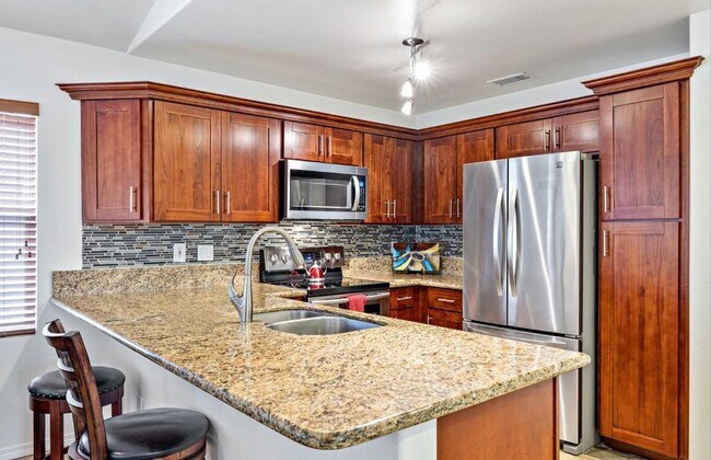 Building Photo - Single Story with large covered patio. Two car garage with uncovered gated parking stall. New vin...