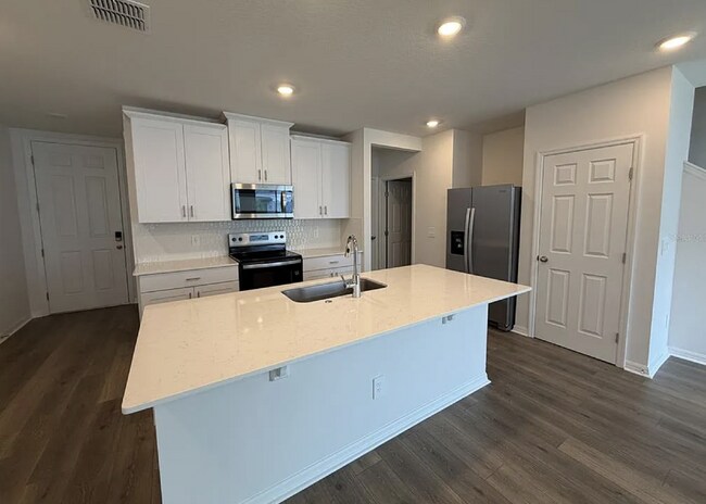 Building Photo - "Spacious 3-Bedroom Townhouse with Granite Elegance in St. Cloud – 4543 Rangeland Way"