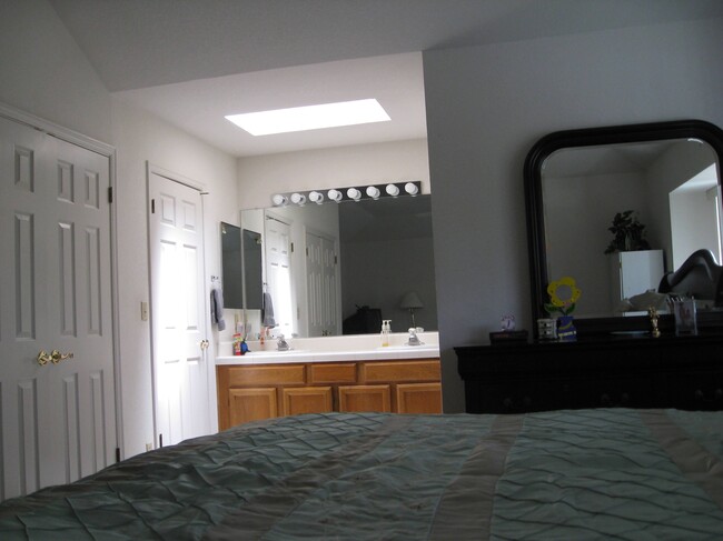 master bedroom with view of 2 closets and sinks - 1148 Chantel Way