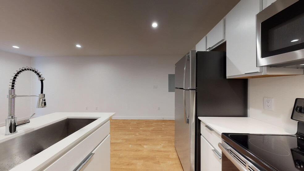 Kitchen with Stainless Steel Appliances, Farmhouse Sink, & Designer Cabinetry - Flamingo