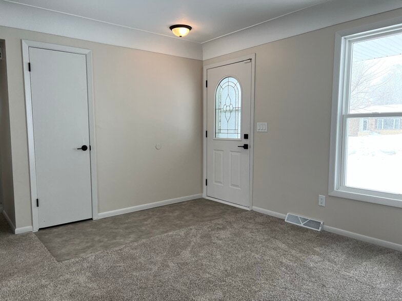 Front Entry features a coat closet and flooring new in 2023 - 835 Maple St NE