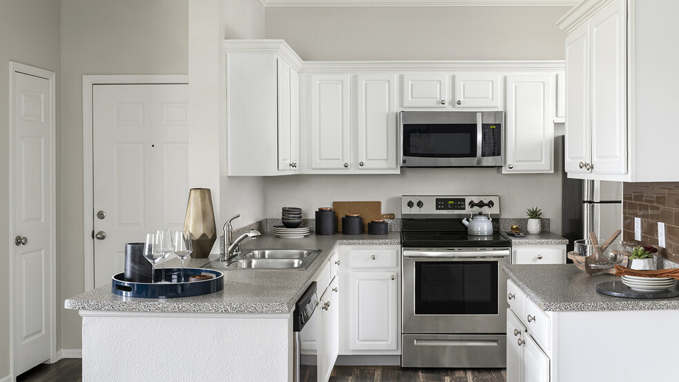 Apartment Kitchen with Stainless Steel Appliances, granite counters and wood floors. - Sagebrook