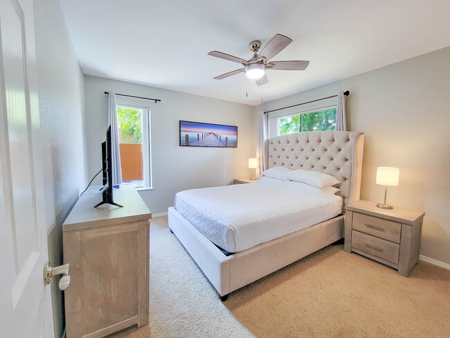 A plush queen size bed with white linens awaits you! - 3500 N Hayden Rd