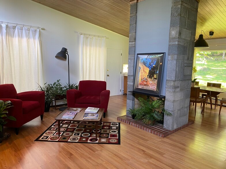 Fireplace divides space between living and dining g area - 983 Cayuga Heights Rd