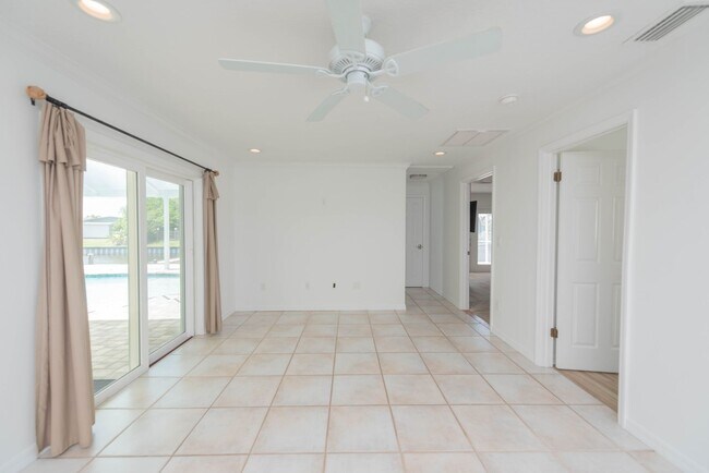 Building Photo - Live the ultimate Space Coast waterfront lifestyle at this stunning beachside canal home in Satel...