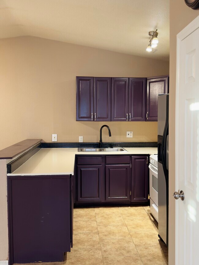 Kitchen with microwave, stove and refrigerator included - 7245 Murray Ln