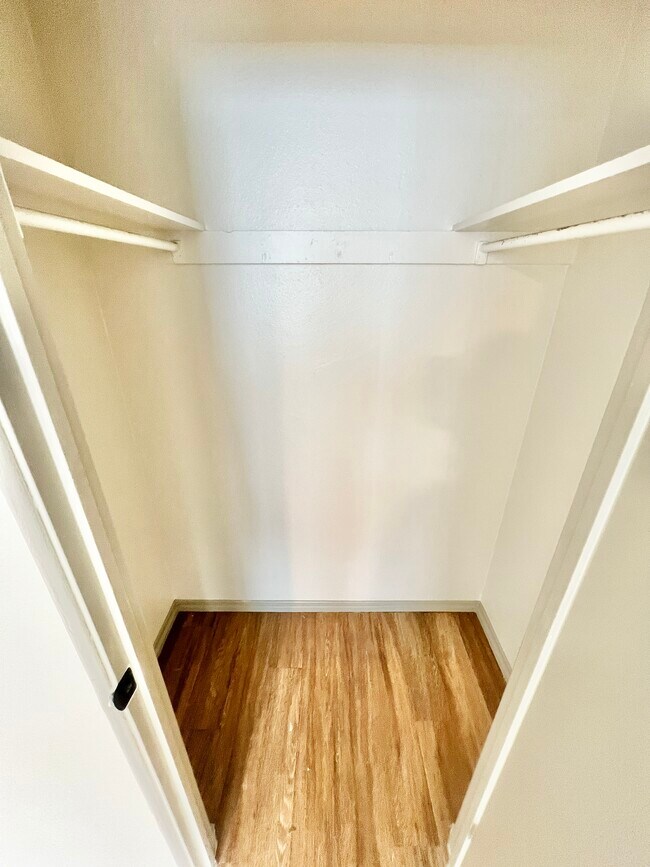 Experience ample storage with this walk-in closet, designed for modern living. - Harmony Apartments