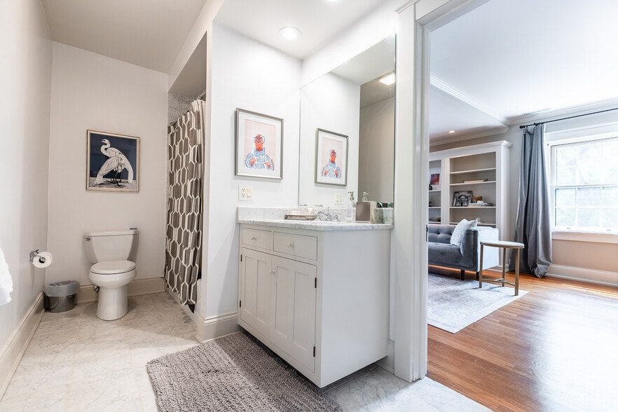 Bath with custom cabinets, Italian marble and bath/shower. - 4061 Beechwood Ave
