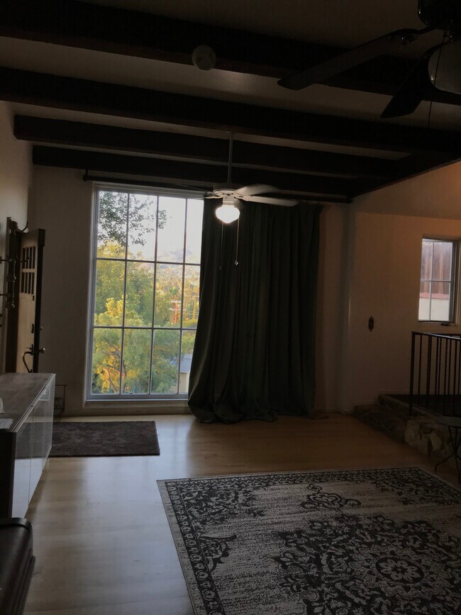Living room front door-left. 9’ view window with draperies for privacy & climate control - 7964 Glenties Ln