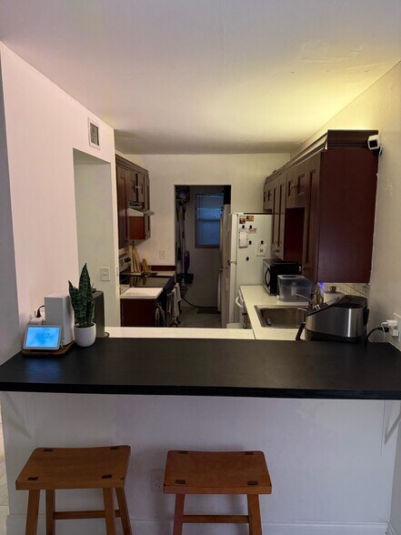 Kitchen with dishwasher and laundry in far back - 2918 NE 8th Ter