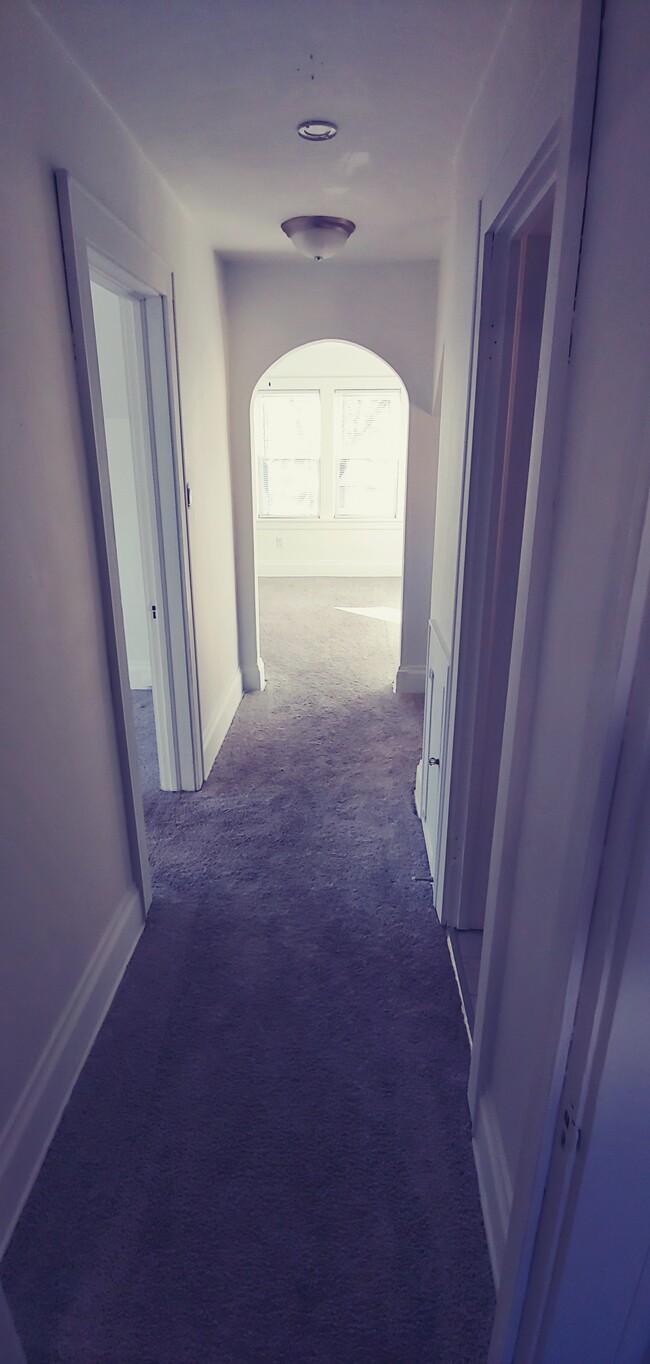 Hallway from Kitchen to Living Area. Bathroom on the right and bedroom on the left. - 5909 33rd Ave