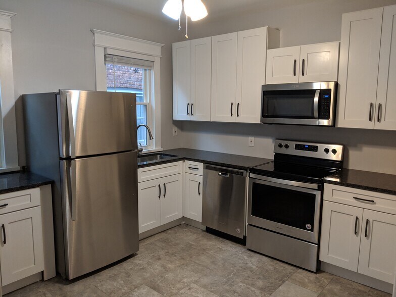 Renovated Kitchen with all stainless steel appliances, granite countertops, and quiet close cabinetry - 32 Pawling Avenue
