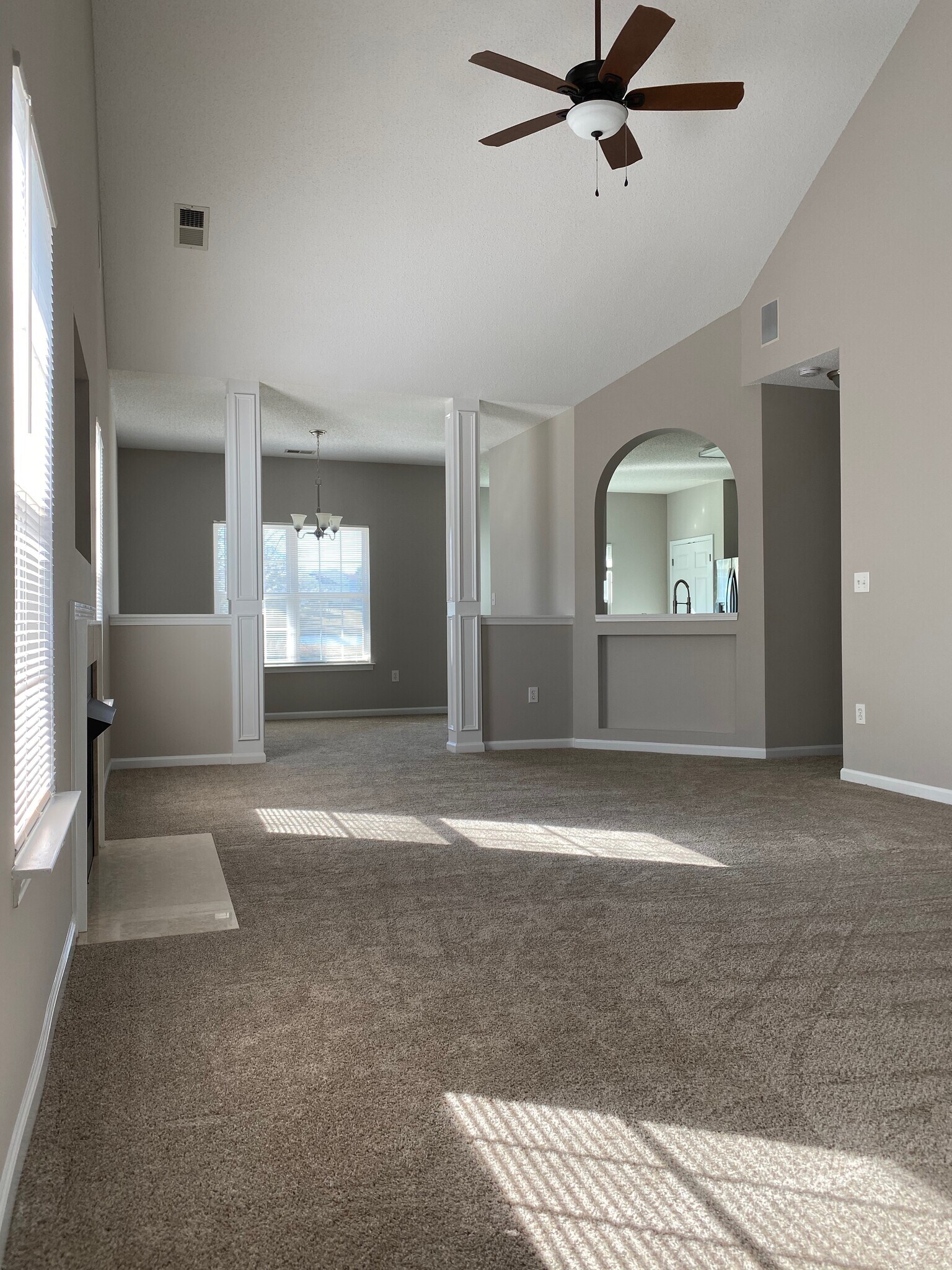 Large great room with vaulted ceiling, ceiling fan, prewired for ATT gigabit fiber optic internet, and surround sound speakers! - 1914 Conifer Cir