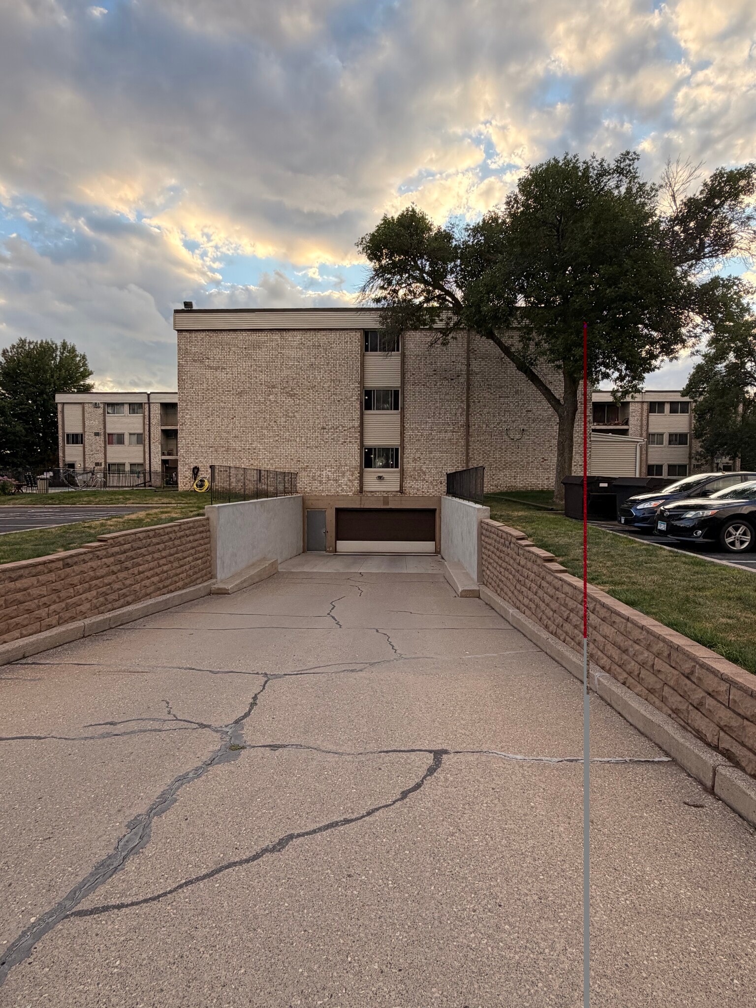 View of basement parking garage with remote power garage overhead door. - 8935 Old Cedar Ave S