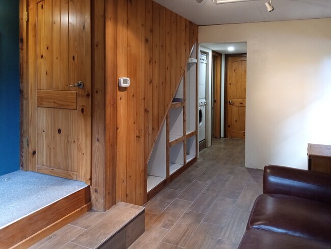 Den area to the laundry, shower, and kitchen. - 8008 149th St NW