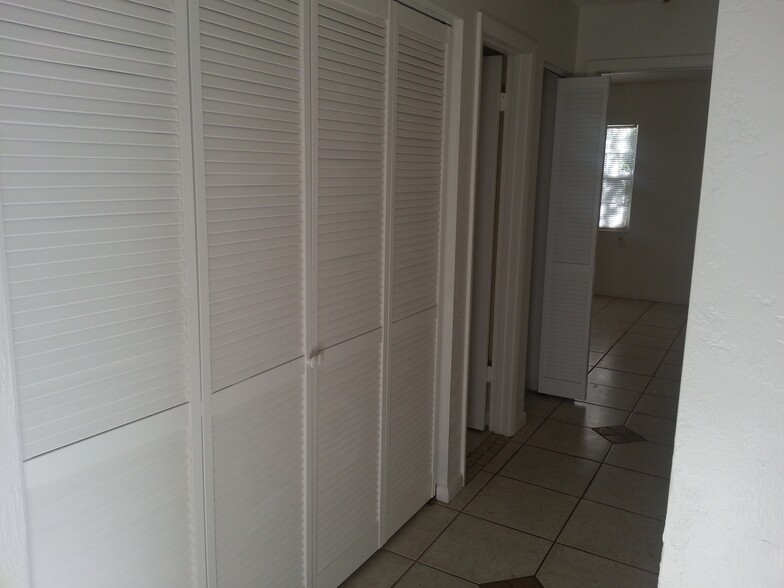 hallway in closet is inside washer and dryer hookup access and storage area - 13 Empress Ln